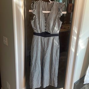 Gingham jumpsuit with cute cutout detail by upper midsection.  Size 6 BCBG